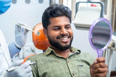man smiling after getting a same-day crown at Prickly Pear Family Dental in Prescott, AZ